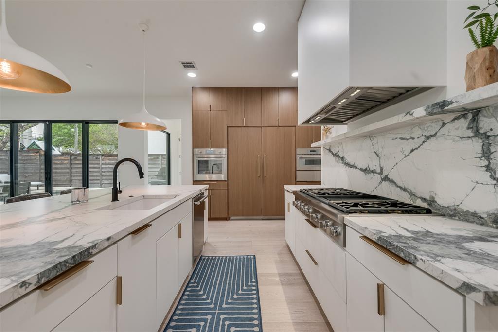 6443 Kenwood Avenue Dallas, TX 75214 - Photo 10 of 21 Kitchen featuring custom range hood, stainless steel appliances, recessed lighting, light stone countertops, and backsplash