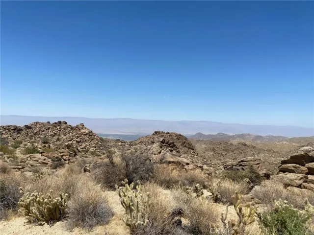a view of a large building with mountains in the background