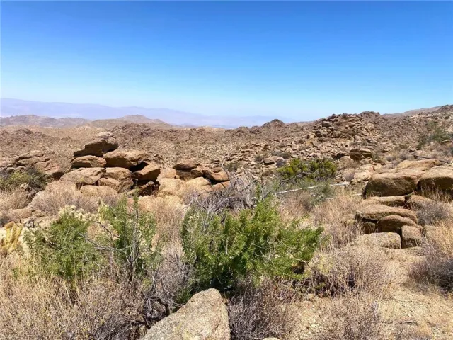an aerial view of mountain with trees around