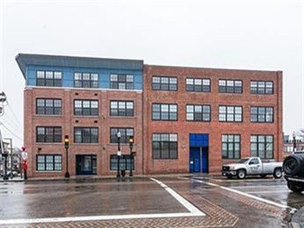 a front view of a residential apartment building with a yard