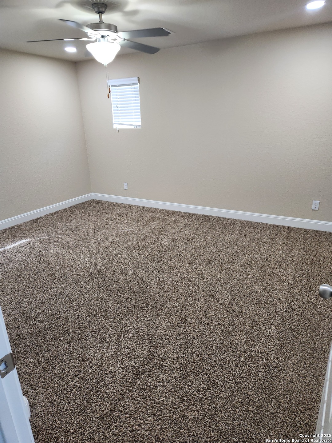 1806 Ayleth Avenue San Antonio, TX 78213 - Photo 11 of 16 an empty room with a chandelier fan
