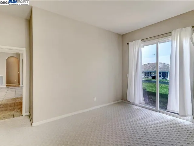 a view of a hallway with wooden shelves