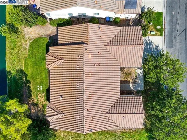 an aerial view of residential houses with outdoor space and parking