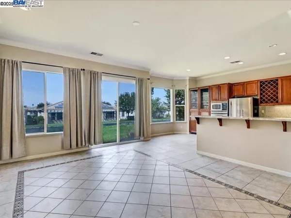 a view of a kitchen with microwave and windows