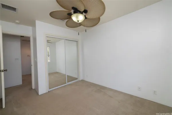 a view of empty room with a chandelier fan
