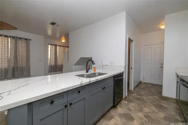 a spacious bathroom with a sink and mirror