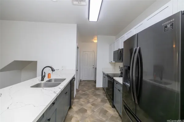 a kitchen with a refrigerator and a sink