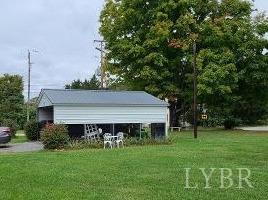4832 Salem Road Spout Spring, VA 24593 - Photo 3 of 16 a view of a house with a big yard potted plants and large tree