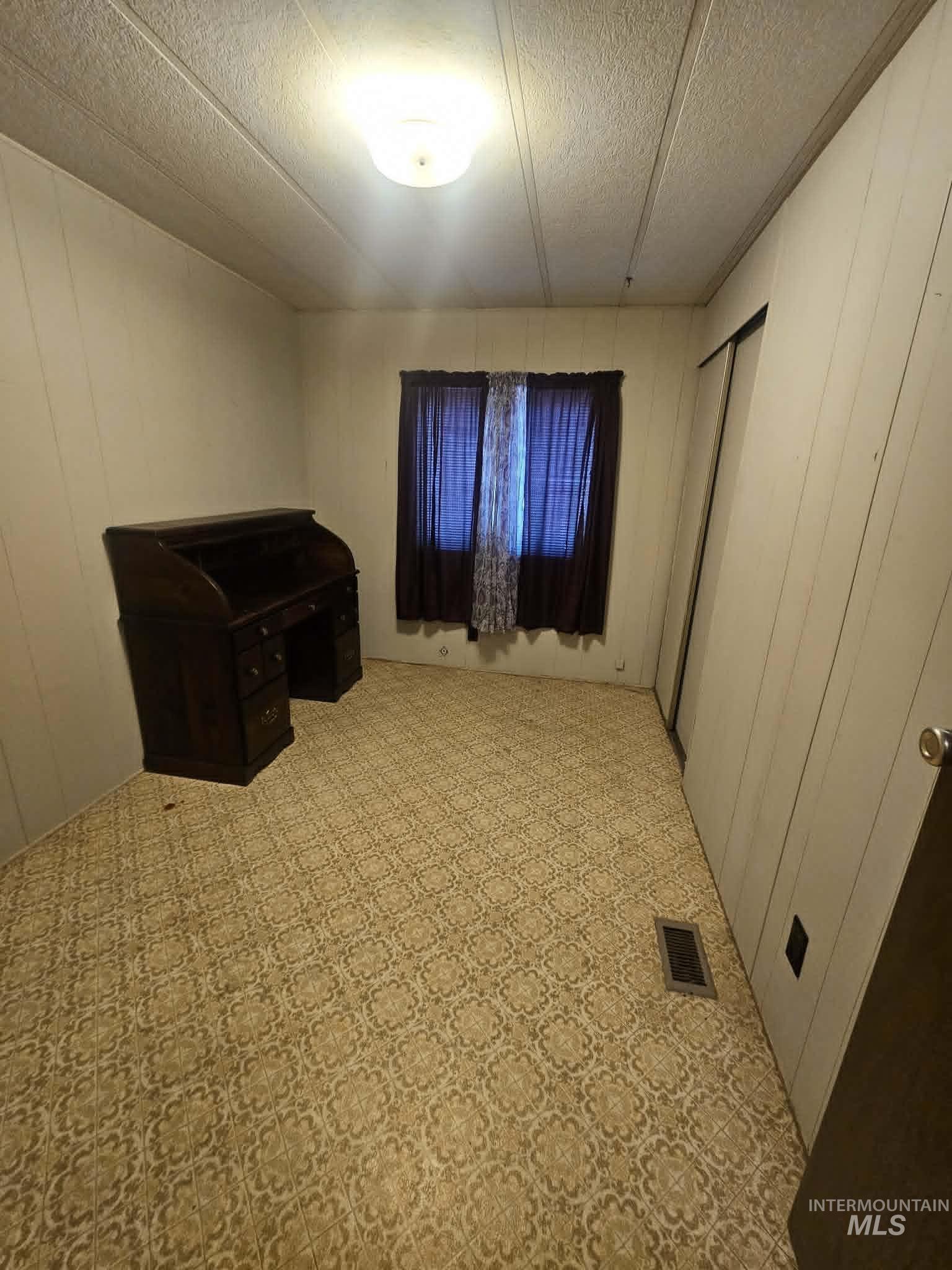 461 Greenleaf Street Boise, ID 83713 - Photo 7 of 19 Room with patterned floor covering and white paneled walls