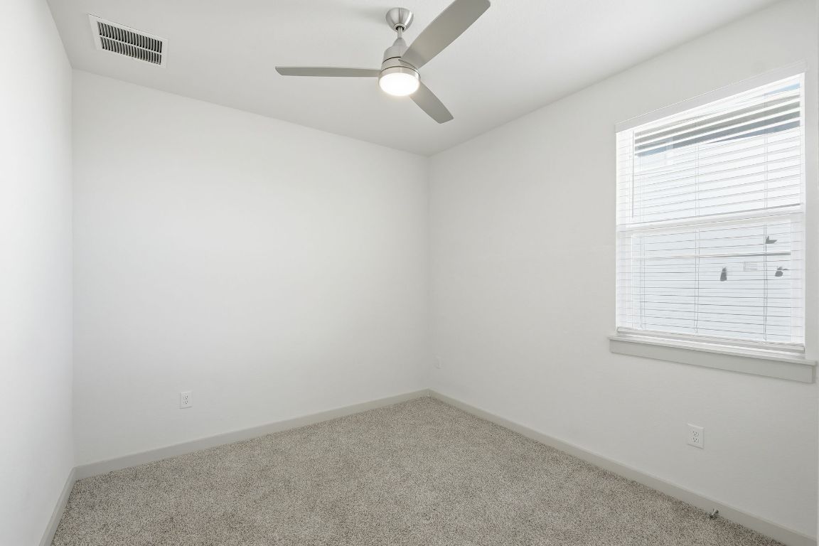 10912 Fulton Avenue Austin, TX 78754 - Photo 9 of 15 an empty room with a window and a fan