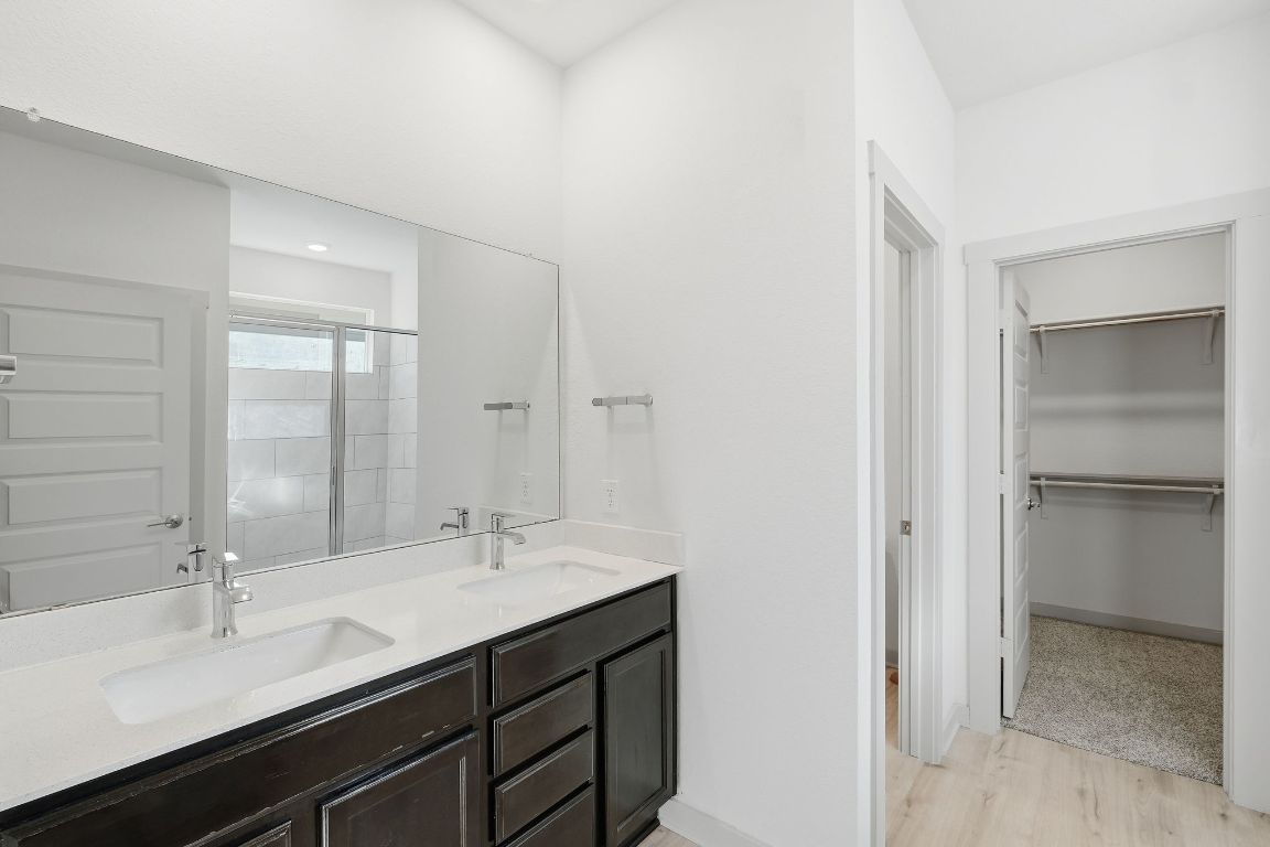 10912 Fulton Avenue Austin, TX 78754 - Photo 5 of 15 a bathroom with a double vanity sink mirror and double