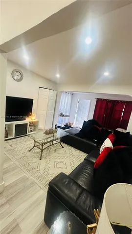 a kitchen with granite countertop a refrigerator a stove top oven a sink and dishwasher