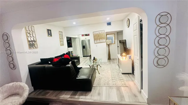 a kitchen with a refrigerator stove and wooden cabinets