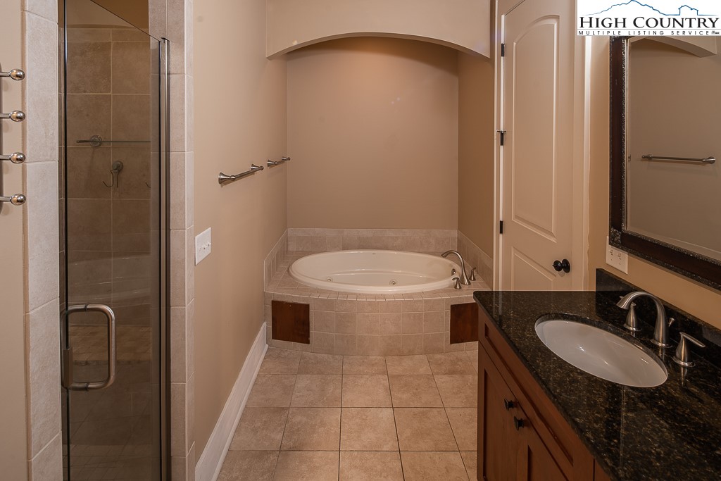 148 Highway 105 Extension, Unit 203 Boone, NC 28607 - Photo 13 of 25 a bathroom with a granite countertop sink toilet and shower