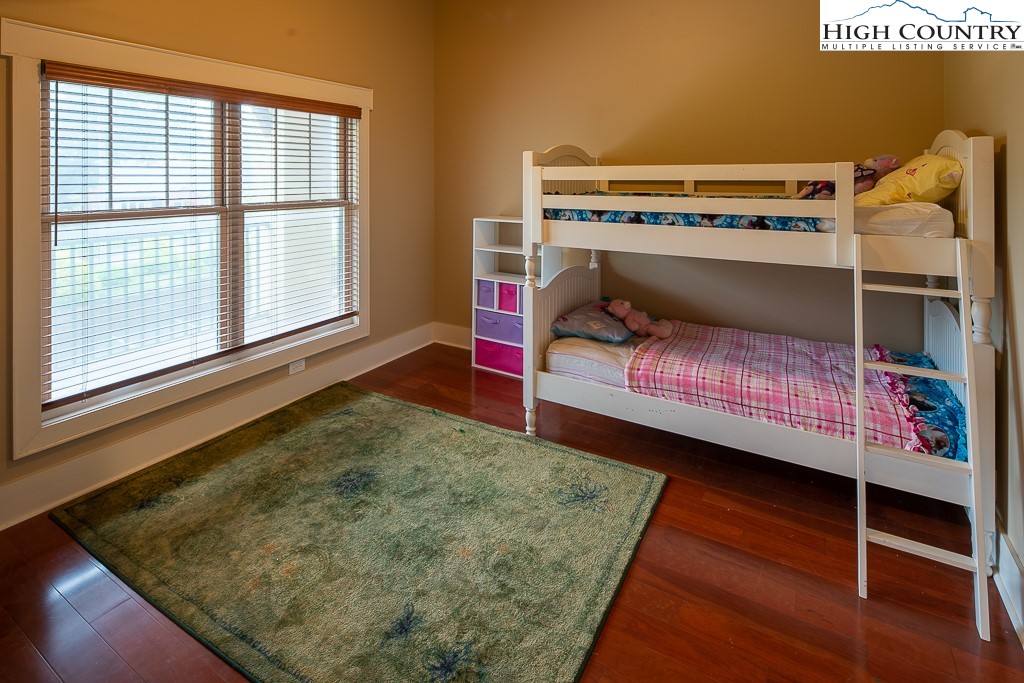 148 Highway 105 Extension, Unit 203 Boone, NC 28607 - Photo 17 of 25 a bed room with a bed and a window