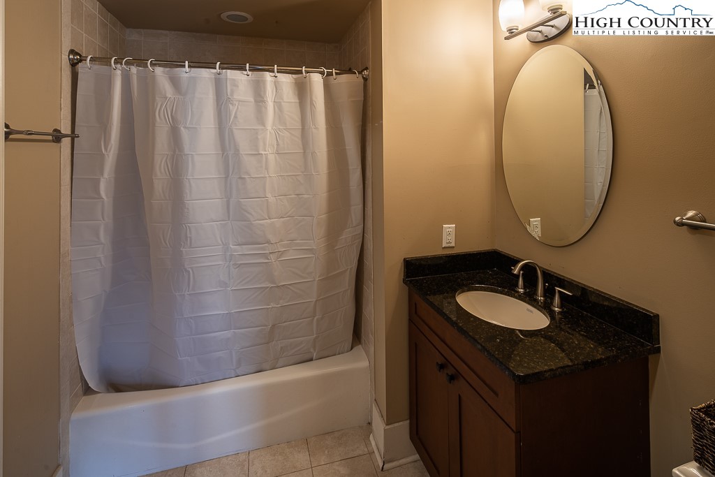 148 Highway 105 Extension, Unit 203 Boone, NC 28607 - Photo 21 of 25 a bathroom with a sink and a mirror