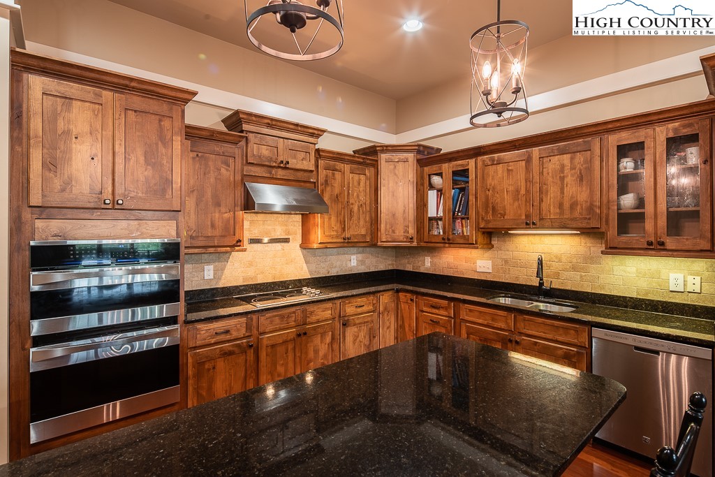 148 Highway 105 Extension, Unit 203 Boone, NC 28607 - Photo 3 of 25 a kitchen with stainless steel appliances granite countertop a stove and cabinets