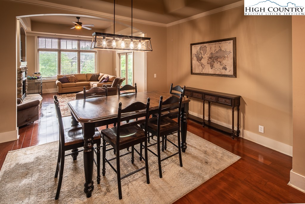 148 Highway 105 Extension, Unit 203 Boone, NC 28607 - Photo 4 of 25 a dining room with furniture a chandelier and wooden floor