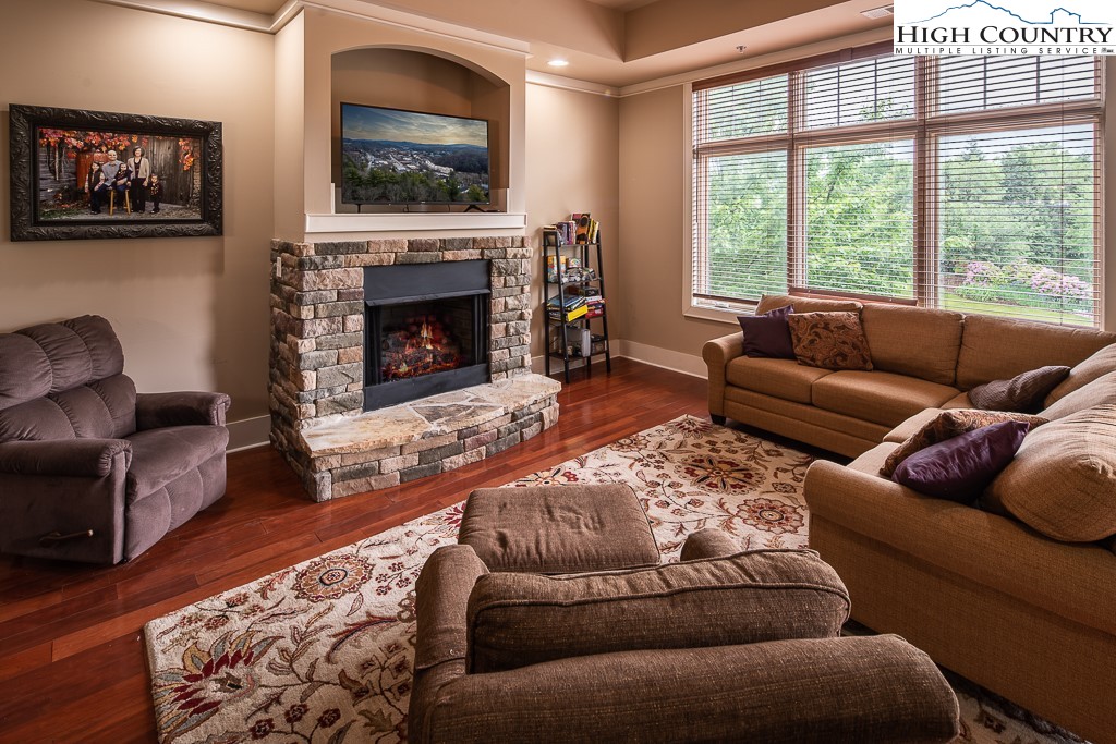 148 Highway 105 Extension, Unit 203 Boone, NC 28607 - Photo 5 of 25 a living room with furniture and a fireplace