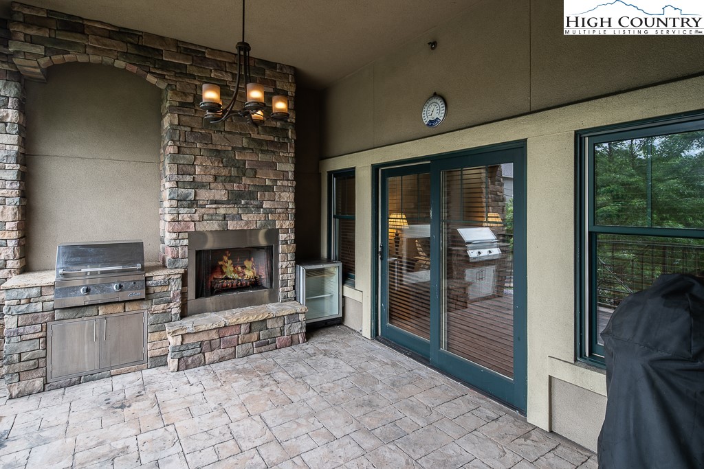 148 Highway 105 Extension, Unit 203 Boone, NC 28607 - Photo 6 of 25 a living room with furniture a flat screen tv and a fireplace