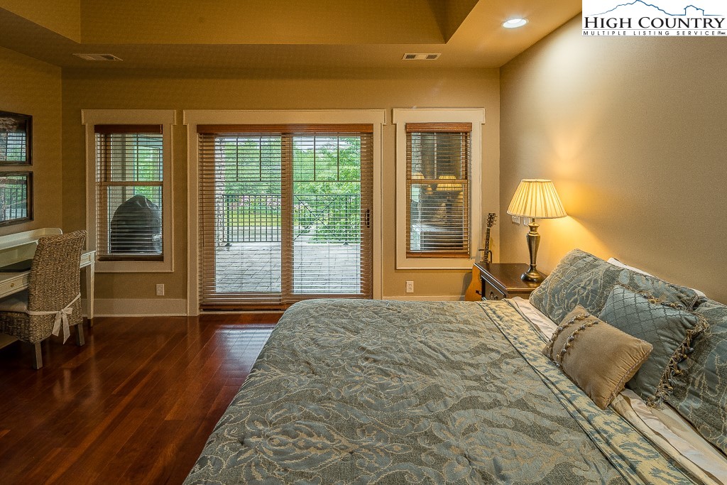 148 Highway 105 Extension, Unit 203 Boone, NC 28607 - Photo 9 of 25 a bed sitting in a bedroom next to a window