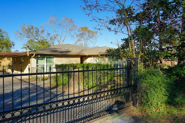 a kitchen with a sink cabinets stainless steel appliances and wooden floor