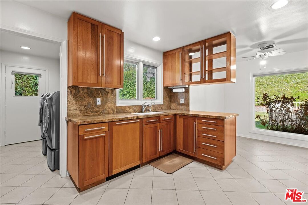 13521 Bayliss Road Los Angeles, CA 90049 - Photo 40 of 46 a kitchen with stainless steel appliances granite countertop a stove a sink and a refrigerator