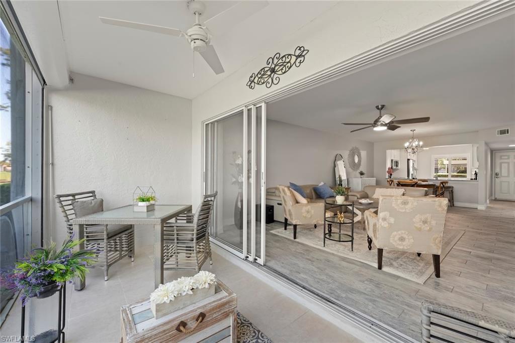 5965 Bloomfield Circle, Unit B104 Naples, FL 34112 - Photo 12 of 39 a living room with furniture and a chandelier