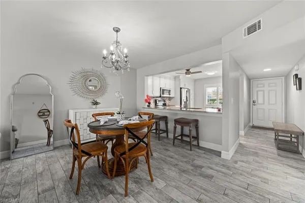 a view of a dining room with furniture and wooden floor