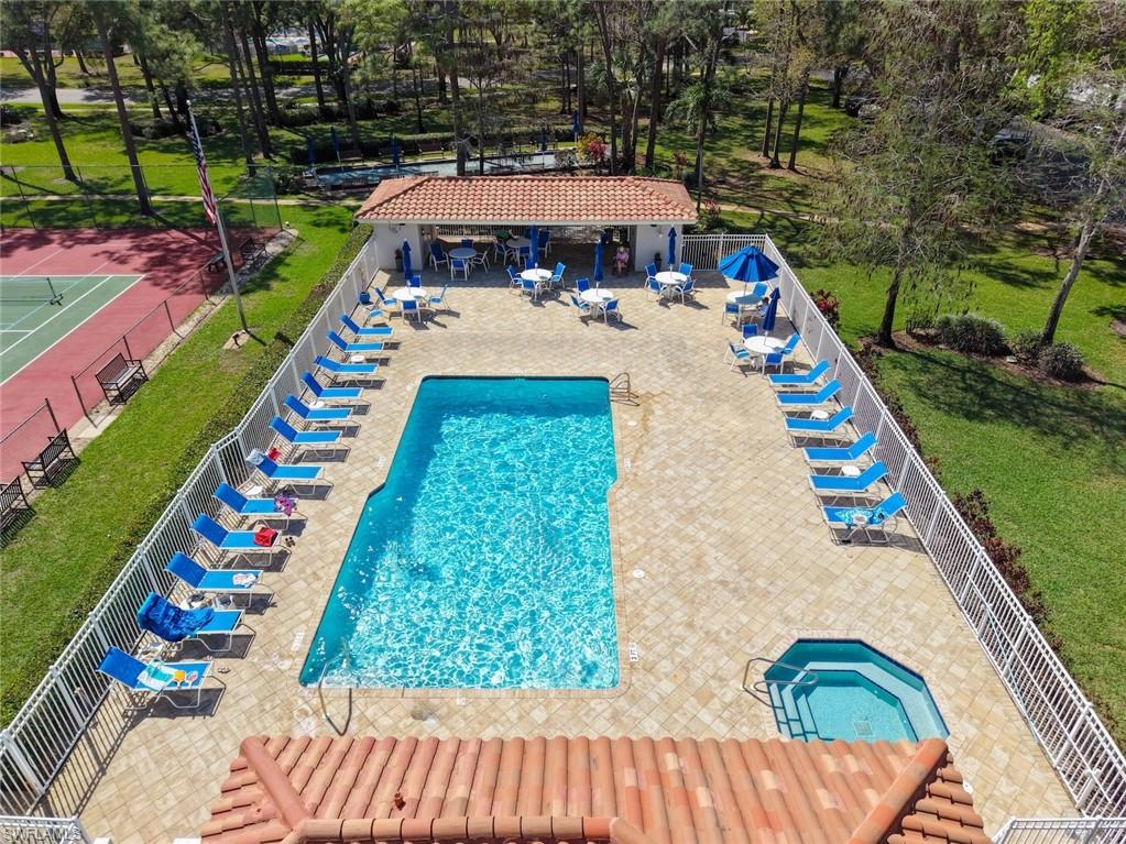 5965 Bloomfield Circle, Unit B104 Naples, FL 34112 - Photo 18 of 39 a view of an outdoor space with a swimming pool