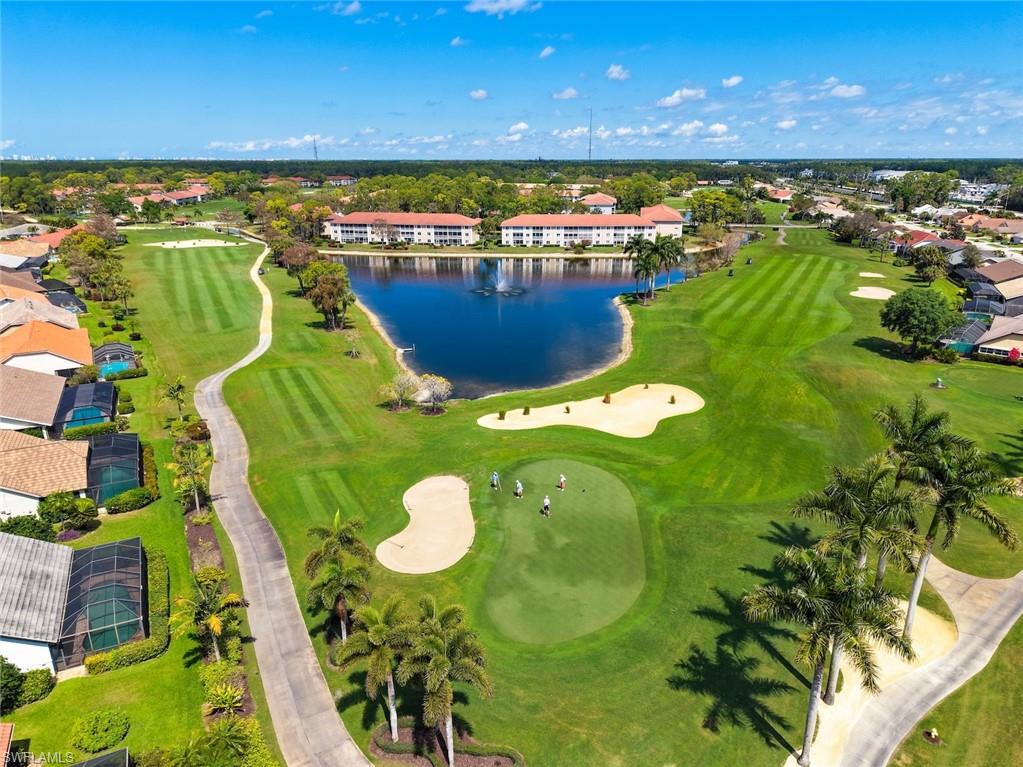 5965 Bloomfield Circle, Unit B104 Naples, FL 34112 - Photo 22 of 39 a view of a lake with a swimming pool
