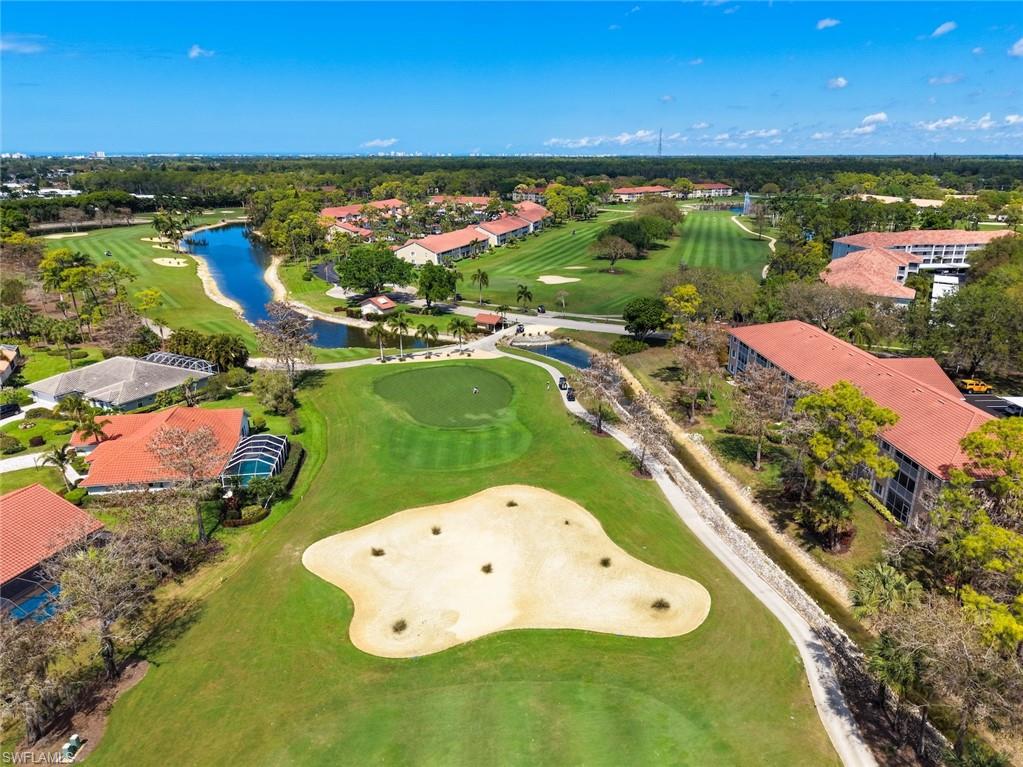 5965 Bloomfield Circle, Unit B104 Naples, FL 34112 - Photo 26 of 39 an aerial view of a golf course with a swimming pool