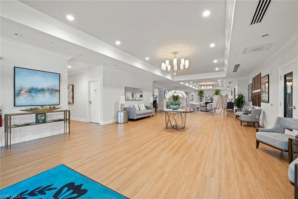 5965 Bloomfield Circle, Unit B104 Naples, FL 34112 - Photo 31 of 39 a living room with furniture and a wooden floor