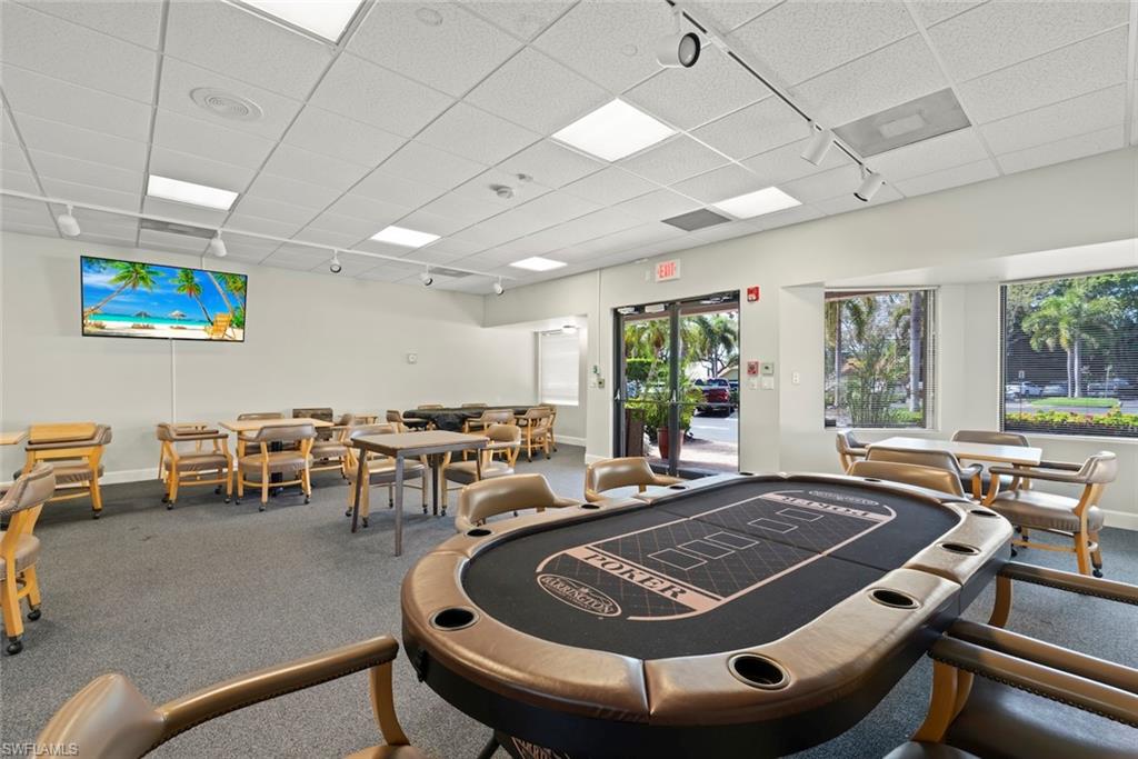 5965 Bloomfield Circle, Unit B104 Naples, FL 34112 - Photo 37 of 39 a room with furniture pool table and a large window