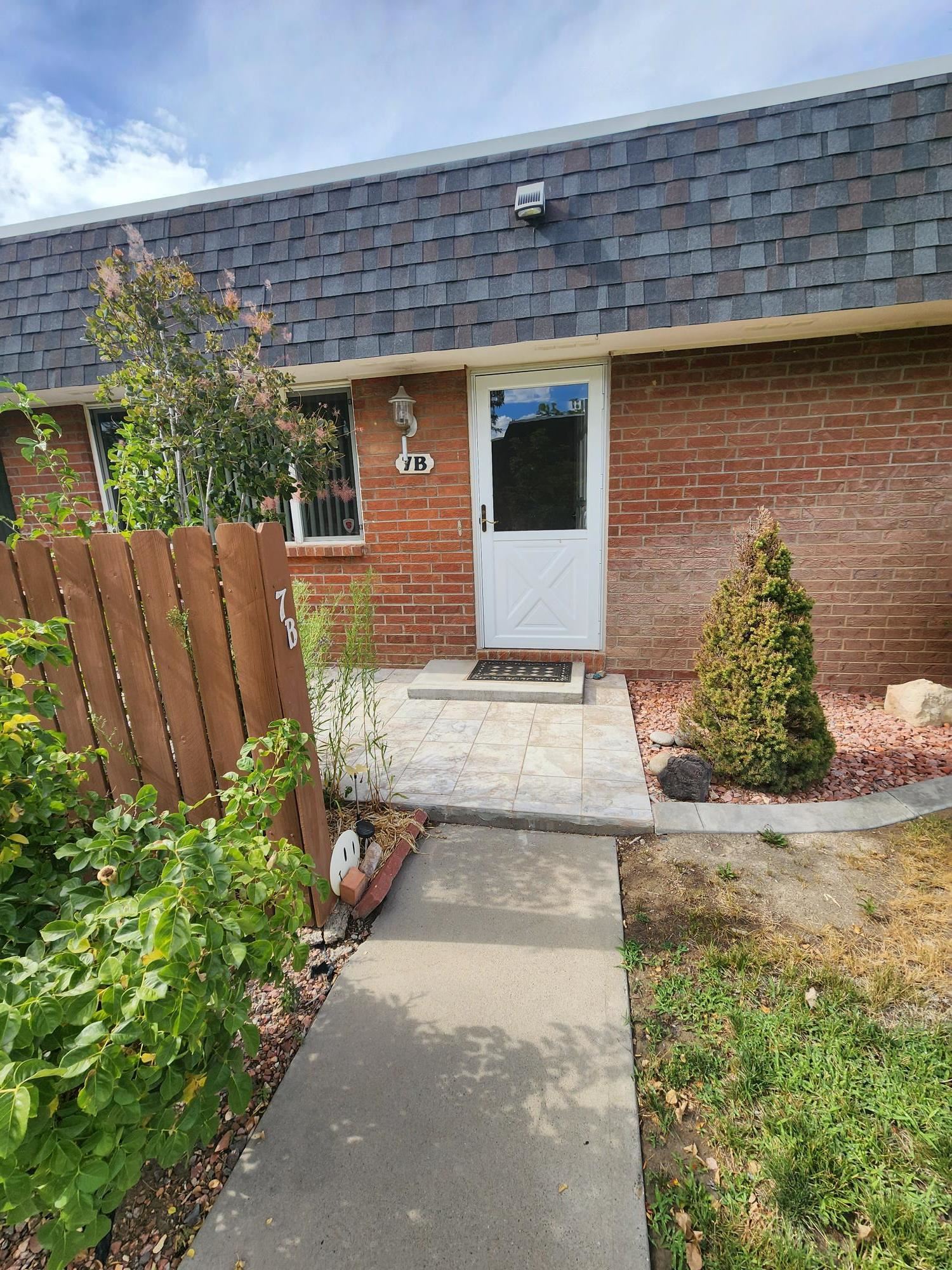 2700 G Road, Unit 7B Grand Junction, CO 81506 - Photo 2 of 31 a front view of a house with a yard