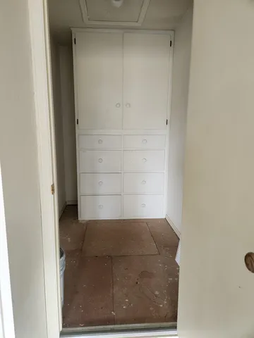a kitchen with a sink refrigerator and cabinets