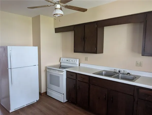 a kitchen with a sink and a refrigerator