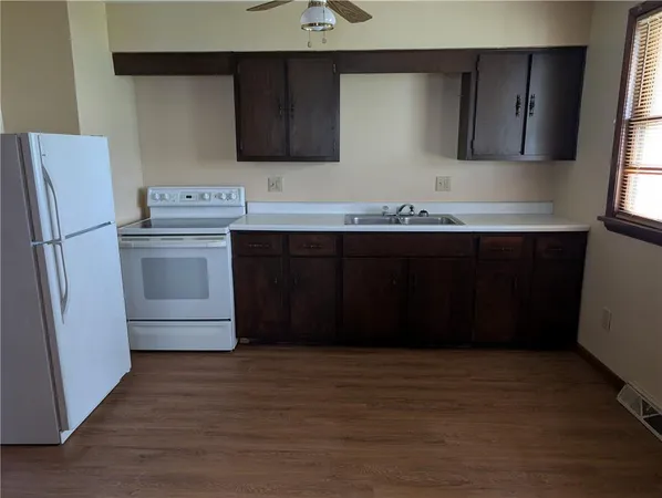 a kitchen with a sink and a refrigerator