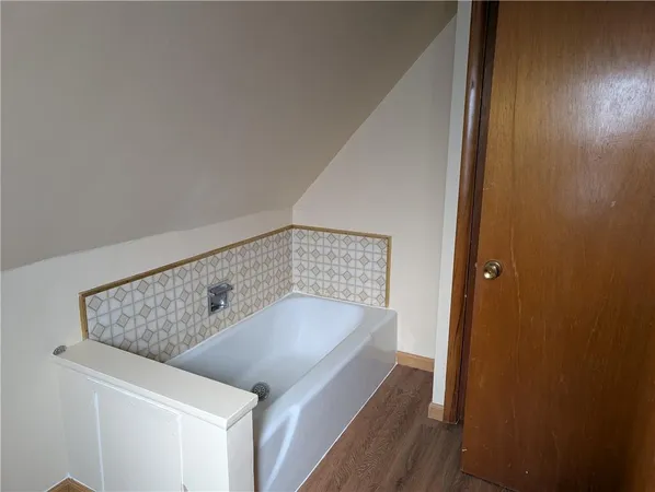 a bathroom with a bathtub and shower