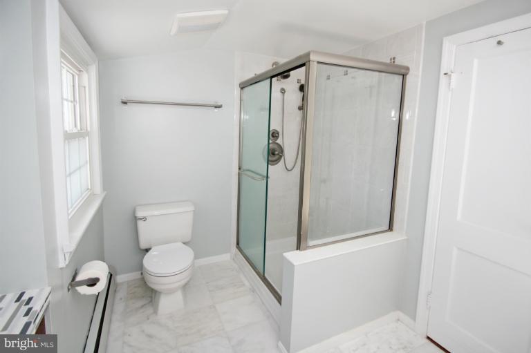 10209 Procter Street Silver Spring, MD 20901 - Photo 2 of 23 a bathroom with a toilet and a shower