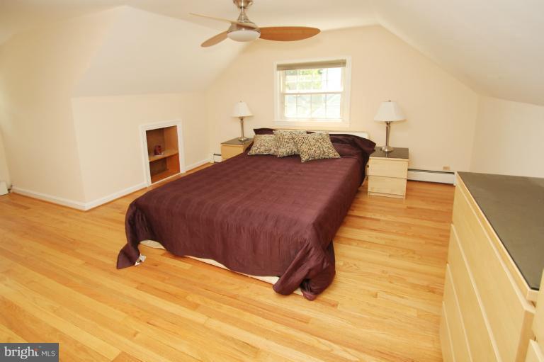 10209 Procter Street Silver Spring, MD 20901 - Photo 17 of 23 a spacious bedroom with a bed and a window
