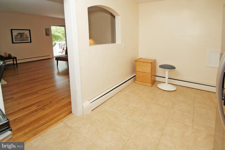 10209 Procter Street Silver Spring, MD 20901 - Photo 19 of 23 a view of an empty room with wooden floor