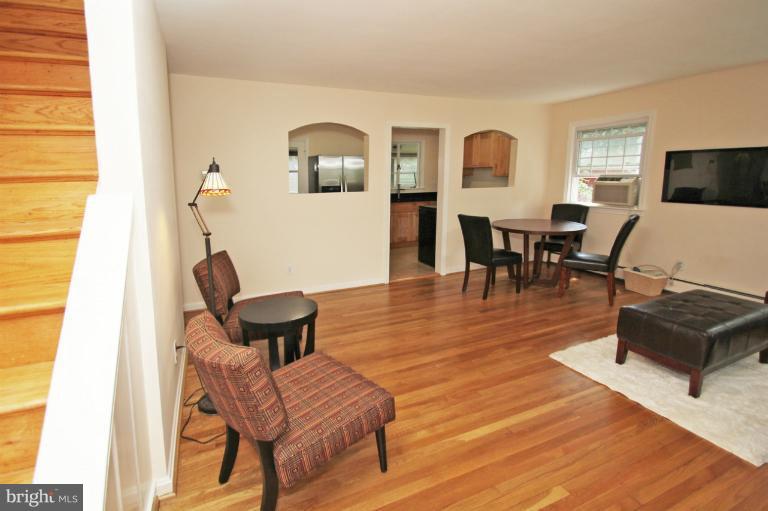 10209 Procter Street Silver Spring, MD 20901 - Photo 3 of 23 a living room with furniture and wooden floor