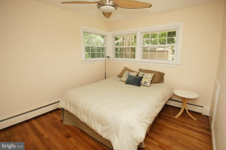 10209 Procter Street Silver Spring, MD 20901 - Photo 21 of 23 a bedroom with a bed and wooden floor