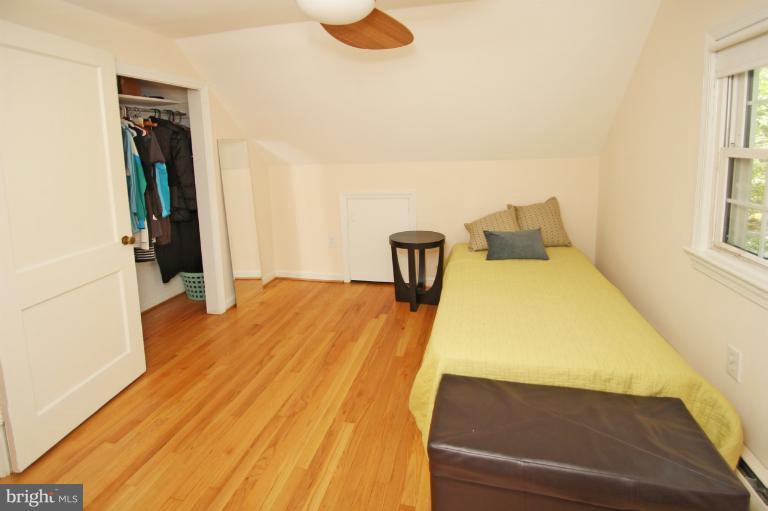 10209 Procter Street Silver Spring, MD 20901 - Photo 6 of 23 a bed room with a bed and a night stand