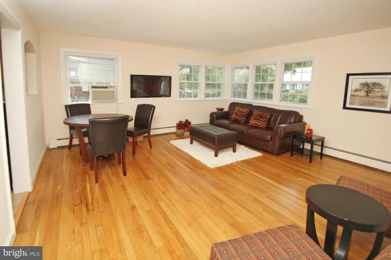 10209 Procter Street Silver Spring, MD 20901 - Photo 9 of 23 a living room with furniture and a flat screen tv