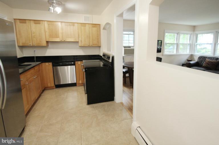 10209 Procter Street Silver Spring, MD 20901 - Photo 10 of 23 a kitchen with a refrigerator and a stove top oven