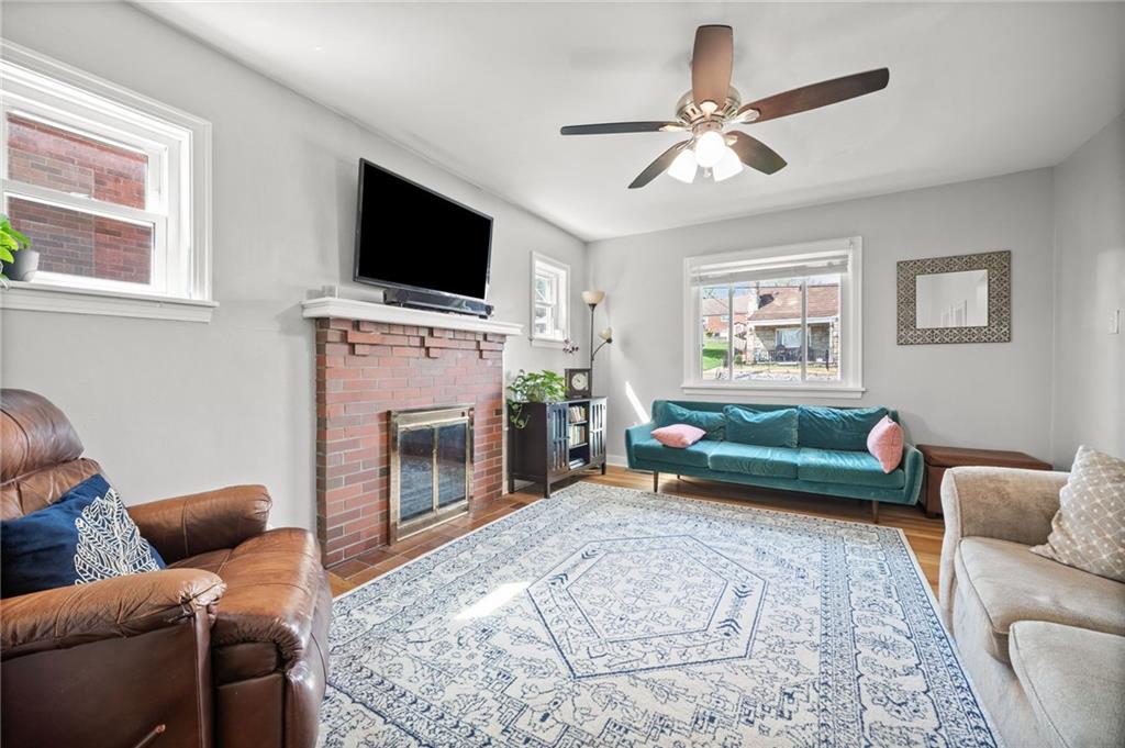 416 Phillips Avenue McKees Rocks, PA 15136 - Photo 8 of 46 a living room with furniture a flat screen tv and a fireplace