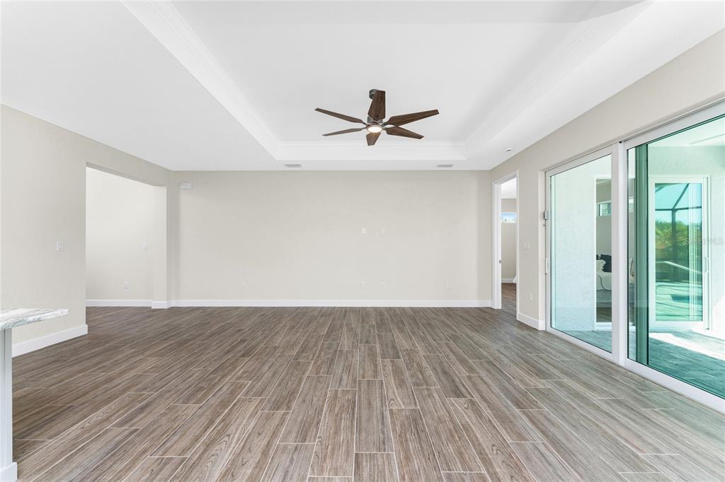 399 Sunset Road Rotonda West, FL 33947 - Photo 11 of 57 wooden floor in an empty room with a window