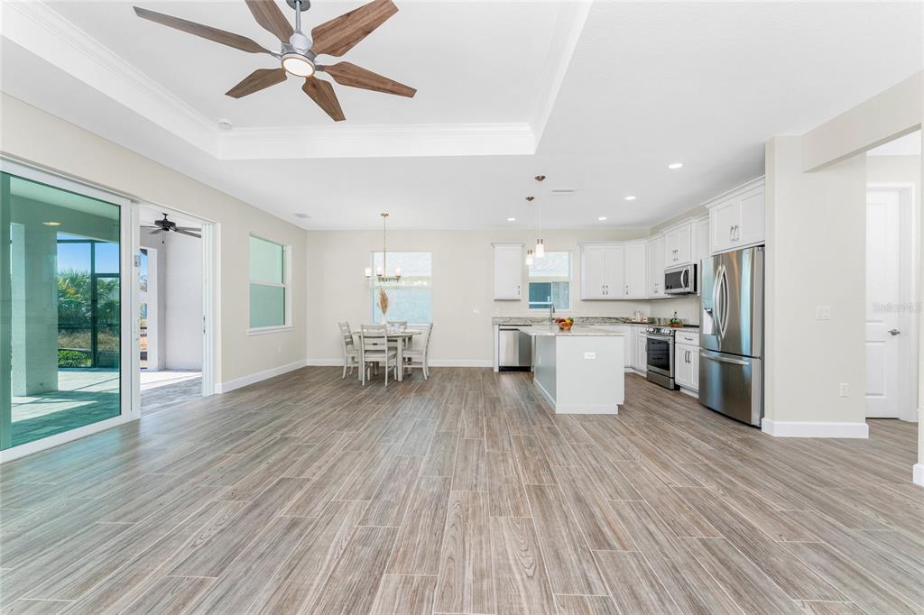 399 Sunset Road Rotonda West, FL 33947 - Photo 13 of 57 a living room with stainless steel appliances kitchen island hardwood floor and a view of kitchen